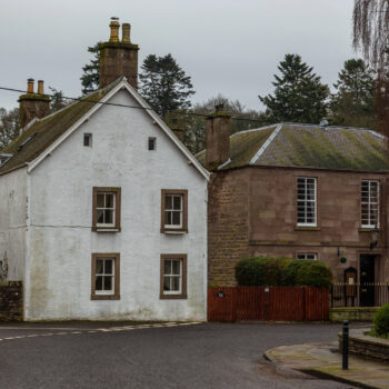 Building in Scotland showing damp staining below guttering