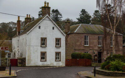Building in Scotland showing damp staining below guttering